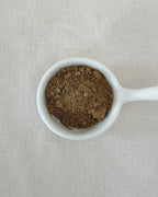 Teappo Red Oolong Powder in a clear container, showcasing the fine, reddish powder texture