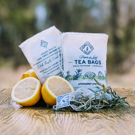 Piper and Leaf Springdrop Spritzer 9ct Tea Bags in Muslin displayed with ingredients including green tea, rosemary, and cardamom.