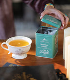 Harney & Sons Tropical Green, Tin of 20 Sachets, featuring a colorful tin design with tropical theme and brand logo.