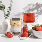 Plum Deluxe Strawberries & Cream Black Tea with Rose in a cup, shown in a lifestyle setting