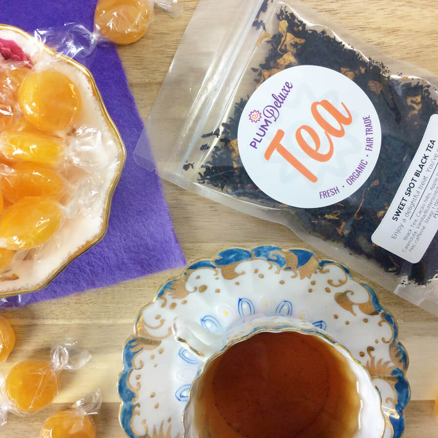 Plum Deluxe Sweet Spot Black Tea (Butterscotch) packaging displayed, featuring a colorful design and tea leaves.