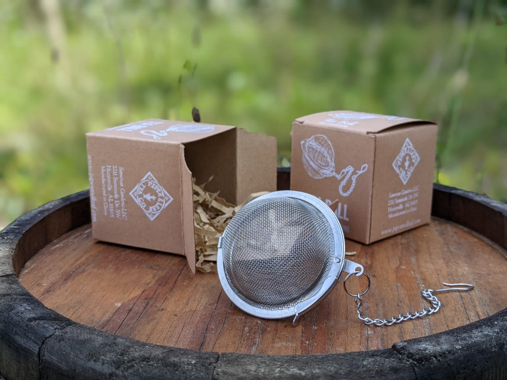 Piper and Leaf Piper Tea Ball, a tea infuser for brewing single servings, showing clasp mechanism and design for steeping loose tea.