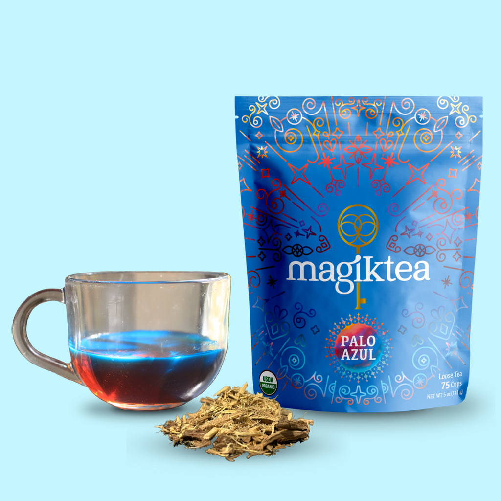 Magiktea Palo Azul tea package with a glass of tea and loose tea leaves on a light blue background