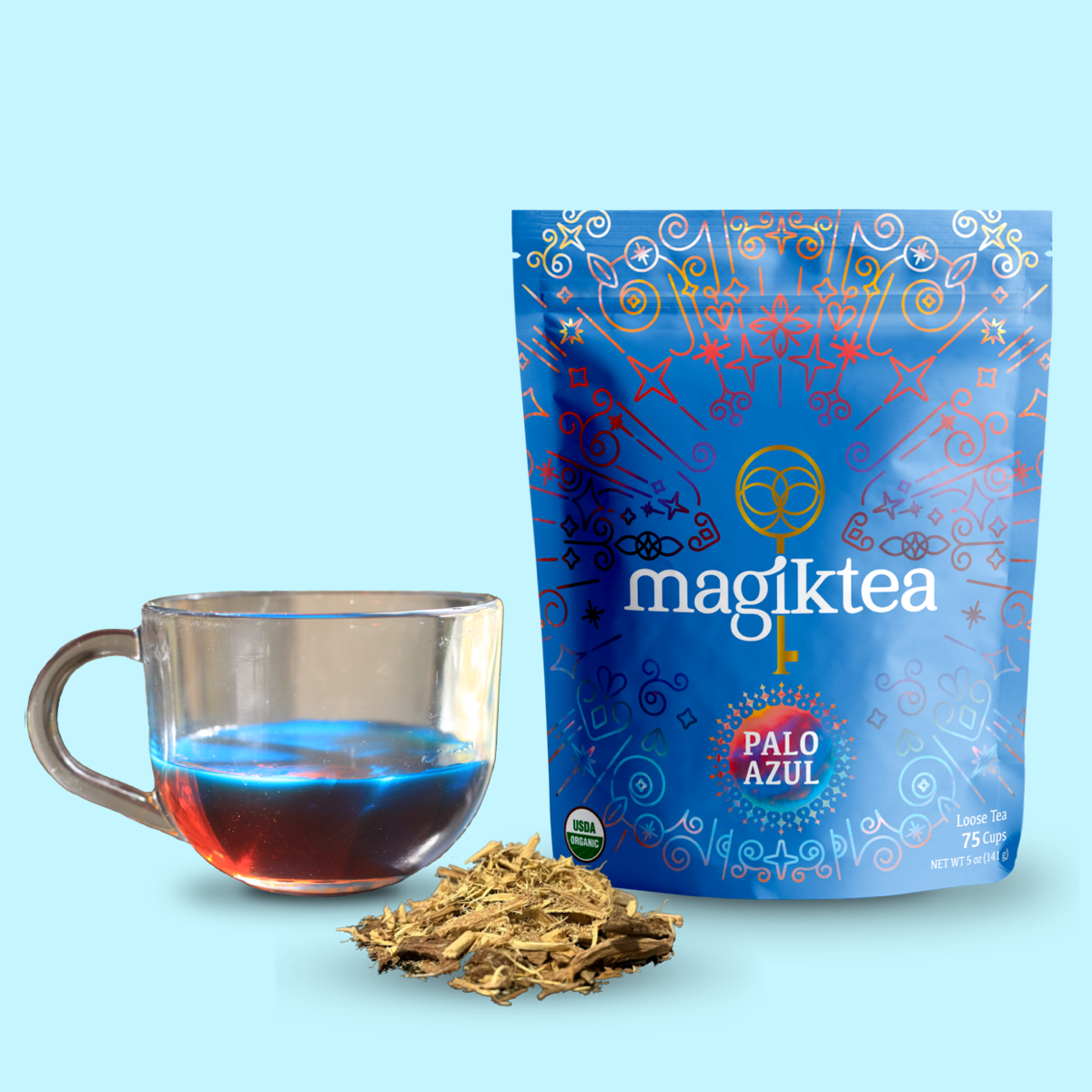 Magiktea Palo Azul tea package with a glass of tea and loose tea leaves on a light blue background