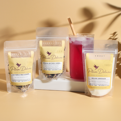 Plum Deluxe Butterfly Pea Sampler Kit featuring butterfly pea flowers, Magic Butterfly Tea, lemonade, and an instructional card.