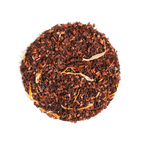 Plum Deluxe Vanilla Creme Herbal Tea in a circular package, showcasing honeybush tea with vanilla cream flavor.
