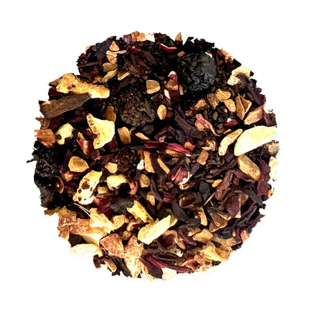 West Peak Yuletide tea by Beach House, featuring loose-leaf blend with organic hibiscus, apple, and spices in a tea infuser.