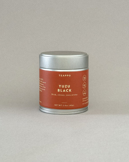 Teappo Yuzu Black Powder in a tea tin, showcasing vibrant yuzu black tea powder, 1.4 oz. (40g) for 25~30 servings.