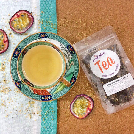 Plum Deluxe Abundance Blend Green Tea (Passionfruit - Elderflower) in a loose leaf format displayed in a clear jar.
