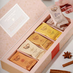 Pinky Up Chai Loose Leaf Tea Sampler featuring assorted tea blends in packaging, displayed on a neutral background.