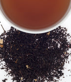 Harney & Sons Cranberry Autumn, Tin of 20 Sachets with a cup of brewed tea, showcasing the tea's rich color and aroma.
