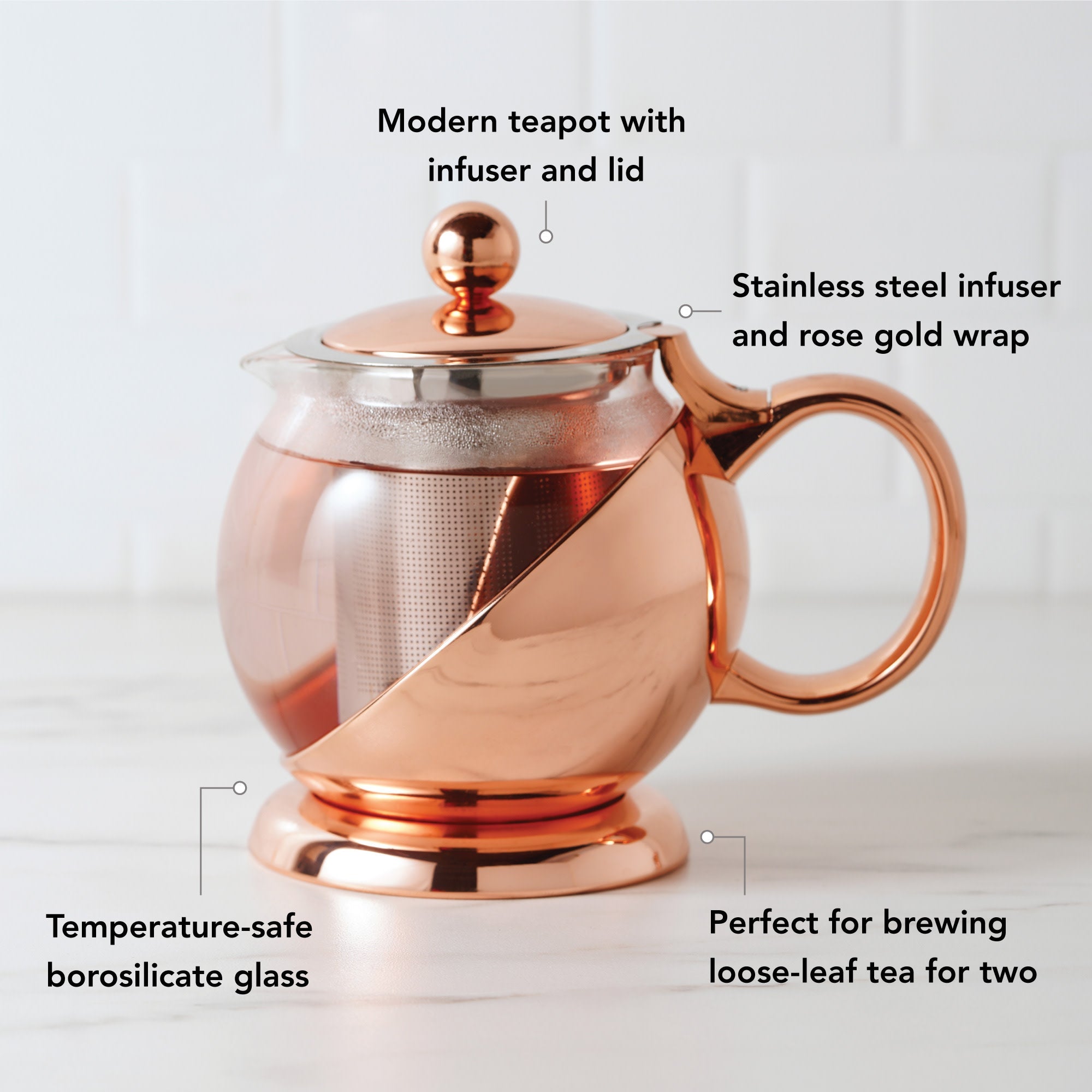 Pinky Up Shelby Glass and Rose Gold Wrapped Teapot on a white background, showcasing its elegant design and color.