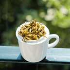 Farmers' Green by Nepal Tea, showing wet green tea leaves in a close-up image