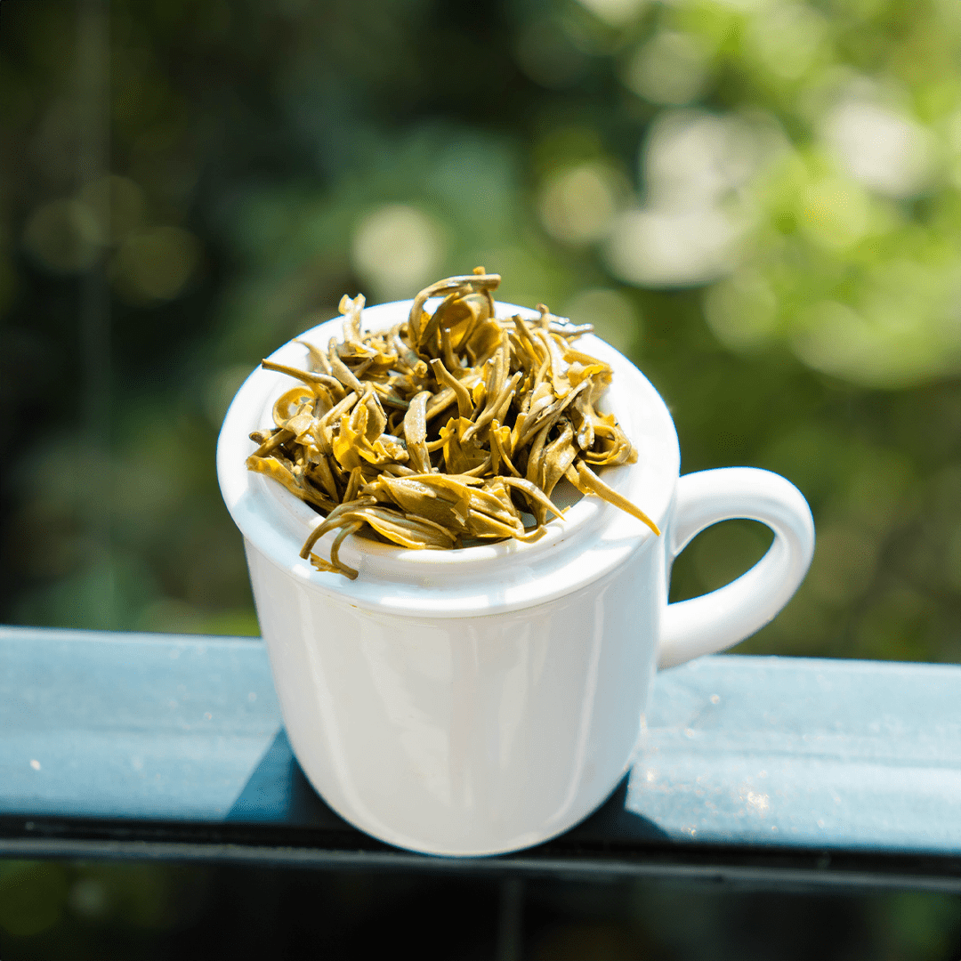Farmers' Green by Nepal Tea, showing wet green tea leaves in a close-up image