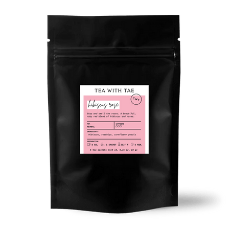 Tea with Tae Hibiscus Rose 5ct. Pouch featuring 5 pyramid sachets of herbal tea blend with hibiscus, rosehips, and cornflower petals.