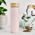 Pinky Up Tatyana Ceramic To-Go Infuser Mug in Lavender displayed on a white background, featuring a removable infuser.