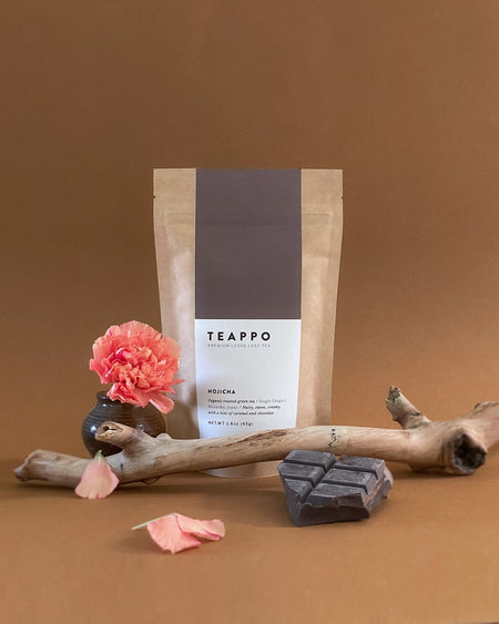 Teappo Hojicha organic roasted green tea, 1.6 oz. package, showcases amber tea leaves with nutty and sweet flavor notes.
