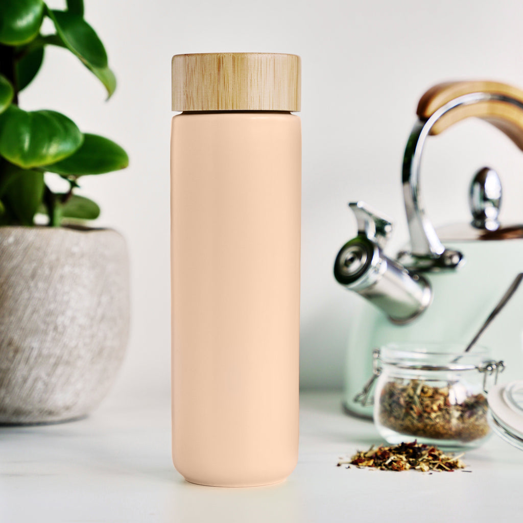 Pinky Up Tatyana Ceramic To-Go Infuser Mug in Coral featuring a sleek design for brewing tea on the go.