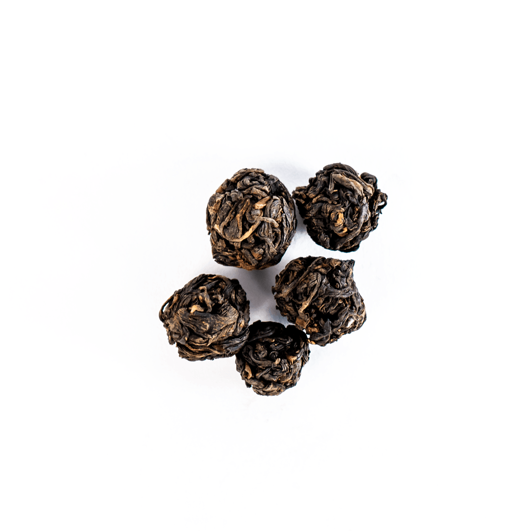 KTE Summer Bloom (Matyangra) loose leaf tea by Nepal Tea in a packaging display, showcasing its vibrant color and texture.