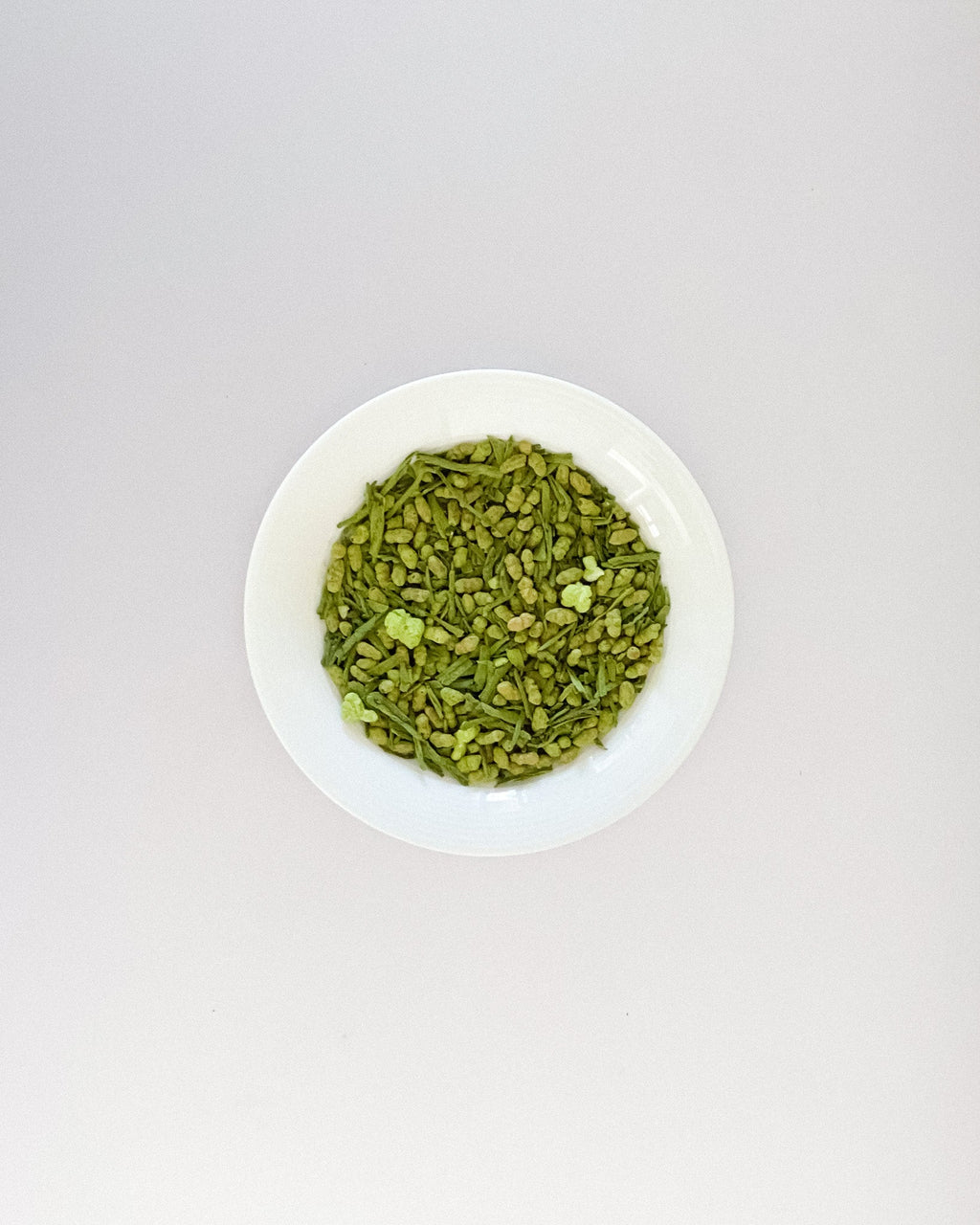 Teappo Matcha Genmaicha, a blend of matcha and roasted brown rice, shown in a tea cup with a whisk