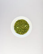 Teappo Matcha Genmaicha, a blend of matcha and roasted brown rice, shown in a tea cup with a whisk