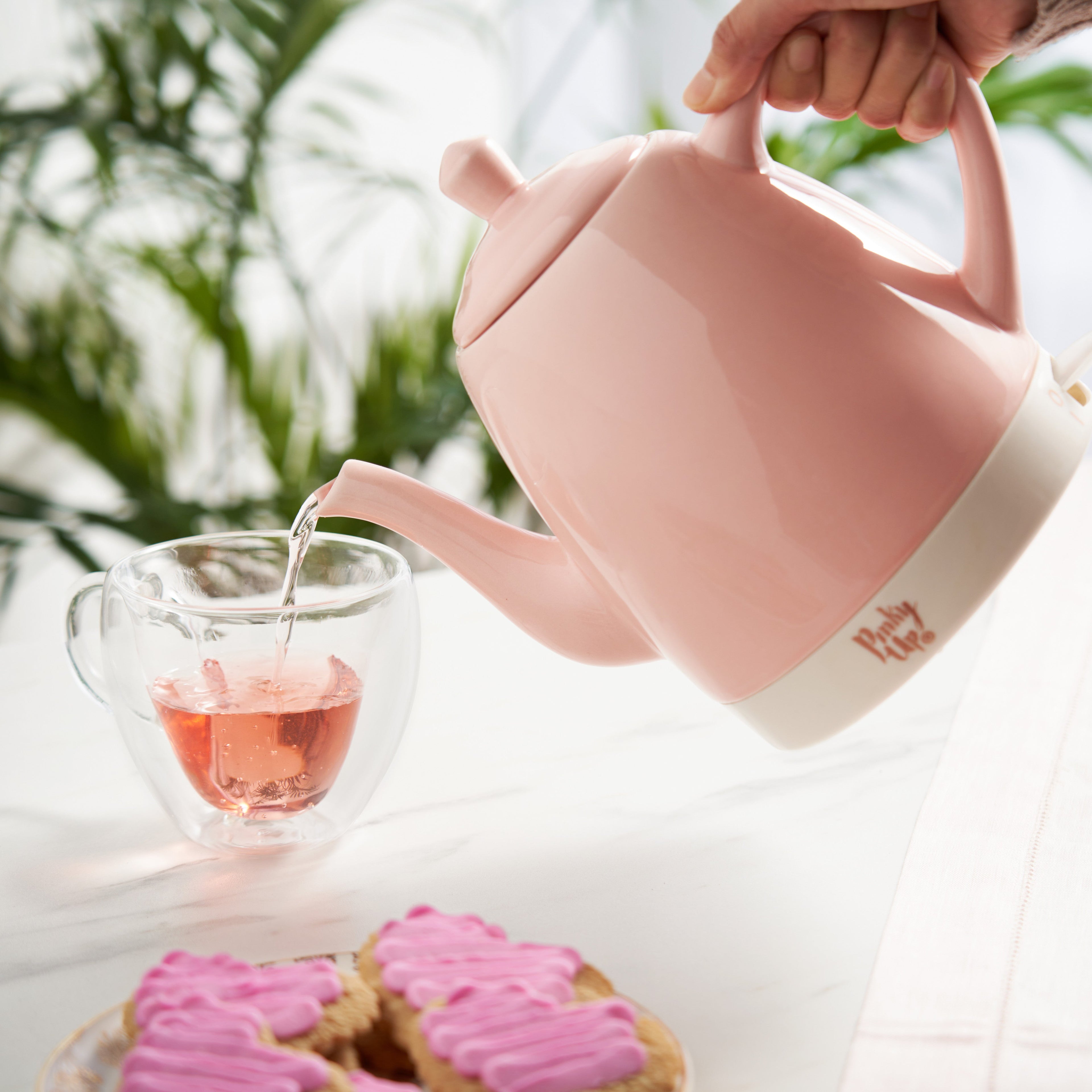 Pinky Up Noelle™ Pink Ceramic Electric Tea Kettle in pink color, shown in a clean and modern design.