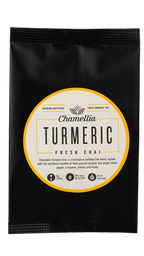 Turmeric Fresh Chai by Somage USA in a cup, showcasing its vibrant yellow color and fragrant spices.