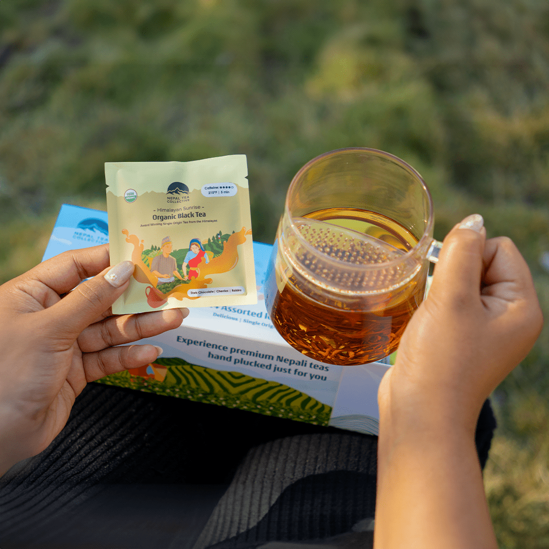 Sampler Box + WALL Tea Infuser by Nepal Tea, featuring assorted tea samples and a wall-mounted tea infuser.