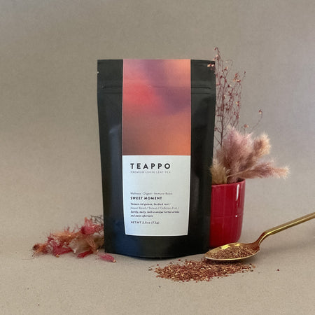 Teappo Sweet Moment herbal blend in a 2.5 oz package, featuring Taiwan red quinoa and burdock root, caffeine-free.