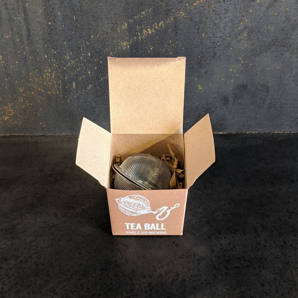 Piper and Leaf Piper Tea Ball in a metal box, featuring a tea infuser with a sleek design for brewing loose leaf tea.