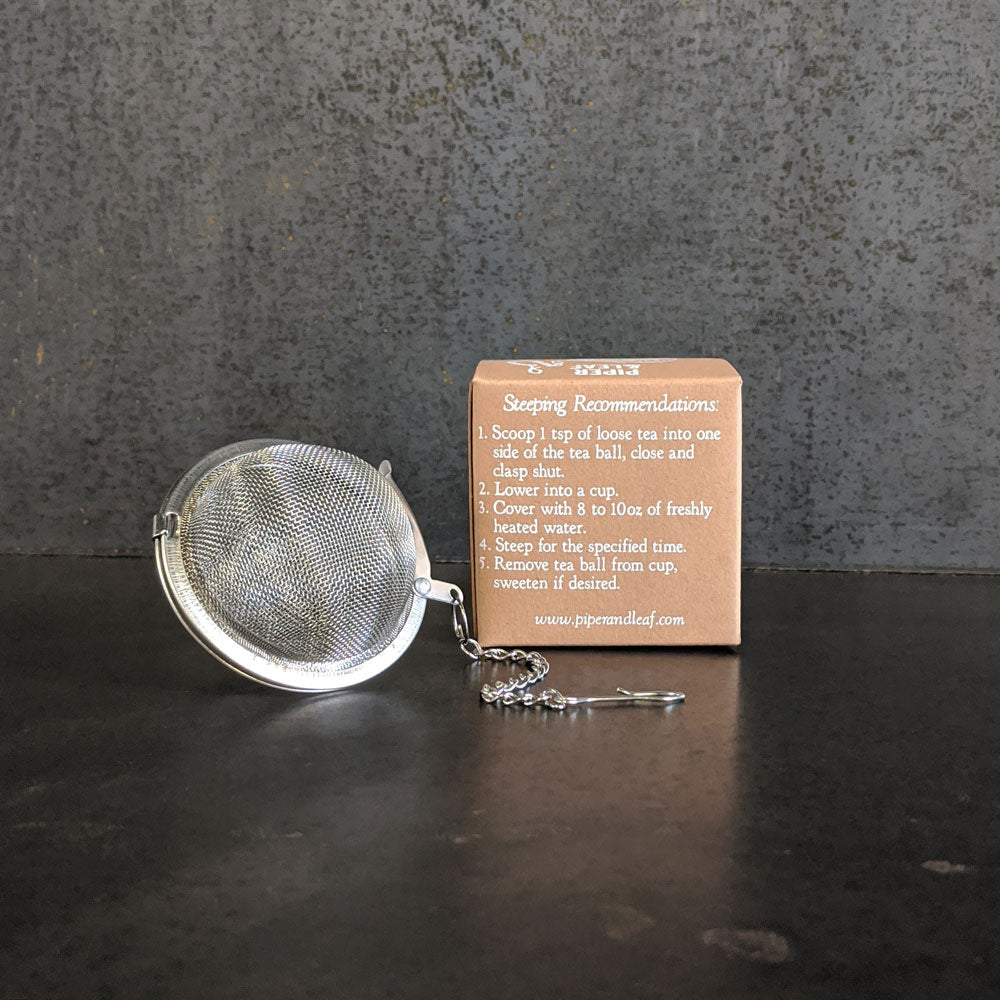 Piper and Leaf Piper Tea Ball displayed, showing metal design and instructions for use