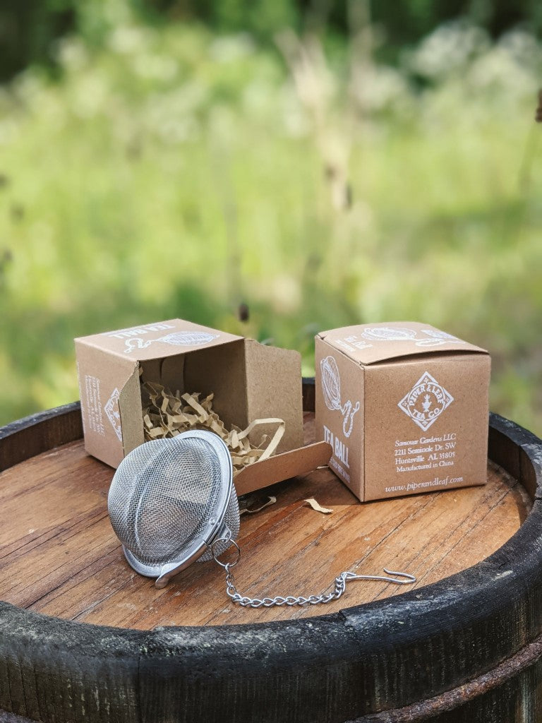 Piper and Leaf Piper Tea Ball displayed in a portrait orientation, featuring a stainless steel design for brewing loose leaf tea.