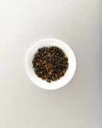 Teappo Osmanthus Oolong tea leaves displayed in a clear container, showcasing the delicate, fragrant tea.