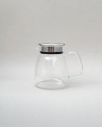 Teappo Simple Teapot, 740 mL glass pot with stainless steel lid, featuring a large arched handle for easy pouring.