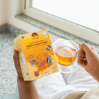Golden Turmeric Ginger by Nepal Tea, featuring dried turmeric and ginger roots in a clear package