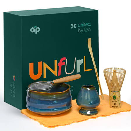 Aprika Life Ceremonial Matcha Starter Kit - Blue in an elegantly designed gift box showcasing matcha accessories and the word "unfurl."