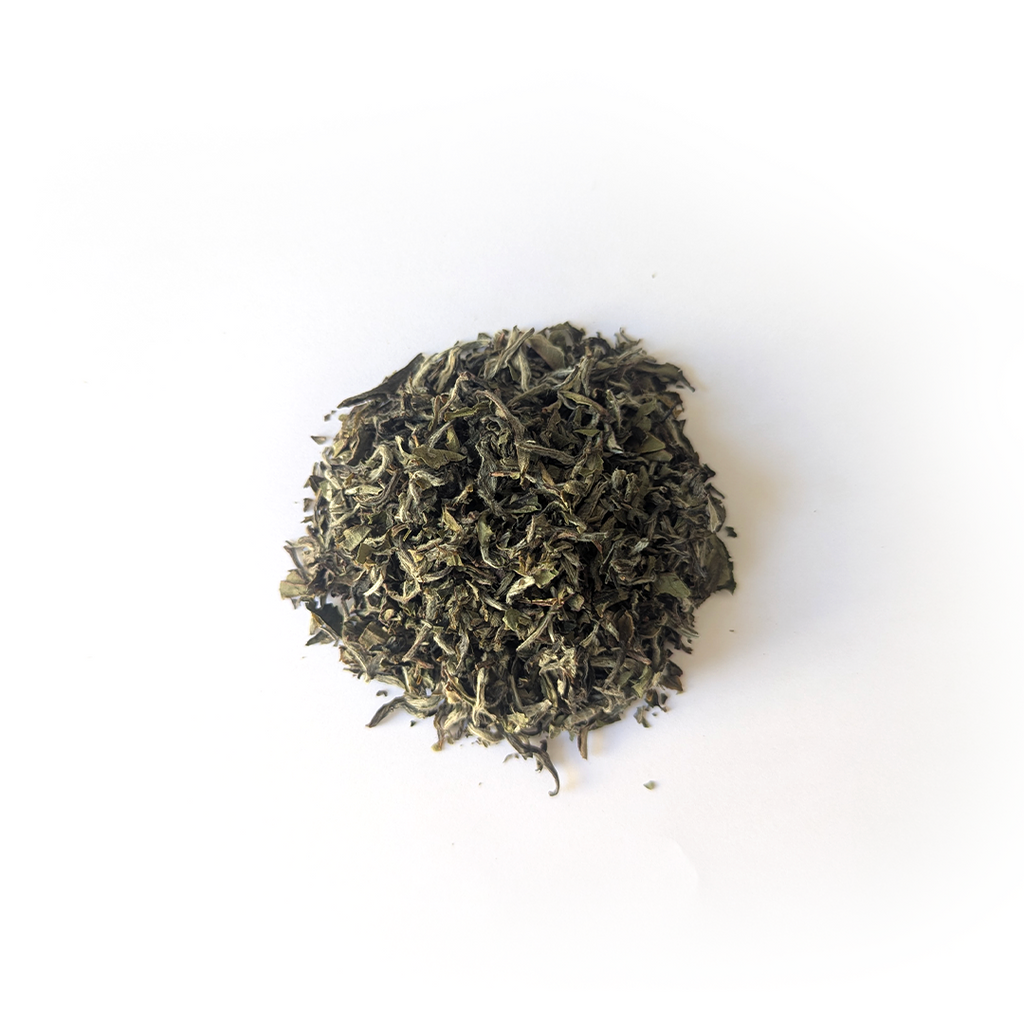 White Tea Jasbire by Nepal Tea, showing dry white tea leaves in a pile, highlighting their natural color and texture.